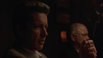 Movie still from “One False Move” (1991), directed by Carl Franklin – A man in a white shirt and a man in a black suit; Close Up shot, Over the shoulder angle