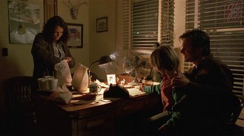 Movie still from “One False Move” (1991), directed by Carl Franklin – A group of people sitting at a table; Medium shot, Low angle