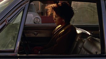 Movie still from “One False Move” (1991), directed by Carl Franklin – A woman sitting in the passenger seat of a car; Close Up shot, Over the shoulder angle
