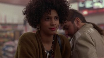 Movie still from “One False Move” (1991), directed by Carl Franklin – A person wearing a necklace; Close Up shot, Over the shoulder angle