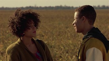 Movie still from “One False Move” (1991), directed by Carl Franklin – A man and a woman standing next to each other in an open field; Close Up shot, Over the shoulder angle