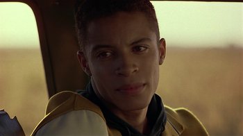 Movie still from “One False Move” (1991), directed by Carl Franklin – A person wearing a jacket; Close Up shot, Over the shoulder angle