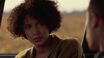 Movie still from “One False Move” (1991), directed by Carl Franklin – A person with curly brown hair; Close Up shot, Over the shoulder angle