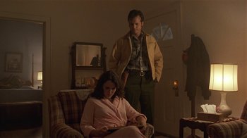 Movie still from “One False Move” (1991), directed by Carl Franklin – A man and a woman standing in a living room next to each other; Medium shot, Low angle