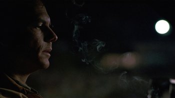 Movie still from “One False Move” (1991), directed by Carl Franklin – A man is smoking a cigarette in the dark; Close Up shot, Low angle