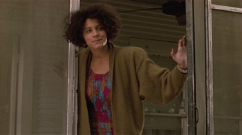 Movie still from “One False Move” (1991), directed by Carl Franklin – A woman standing in front of an open door; Close Up shot, Low angle