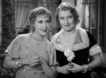Movie still from “One Hour with You” (1932), directed by George Cukor – A couple of women standing next to each other; Close Up shot, High angle