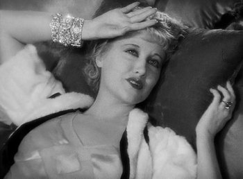 Movie still from “One Hour with You” (1932), directed by George Cukor – A black - and - white photo of a woman in a fur coat; Close Up shot, High angle