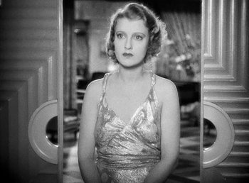 Movie still from “One Hour with You” (1932), directed by George Cukor – An old photo of a woman standing in a doorway; Close Up shot, High angle