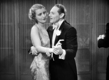 Movie still from “One Hour with You” (1932), directed by George Cukor – A man and a woman in formal wear dancing; Medium shot, Low angle