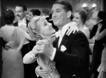 Movie still from “One Hour with You” (1932), directed by George Cukor – A man and a woman are dancing in formal wear; Medium shot, Low angle