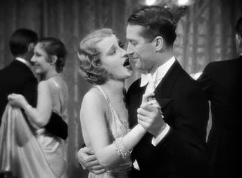 Movie still from “One Hour with You” (1932), directed by George Cukor – A man and a woman dancing at an event; Medium shot, Low angle