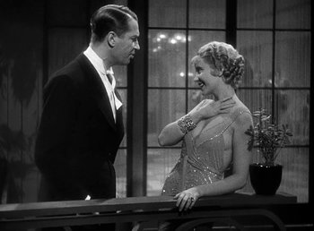 Movie still from “One Hour with You” (1932), directed by George Cukor – A man and a woman standing next to each other; Medium shot, Over the shoulder angle