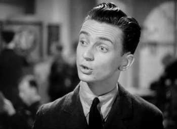 Movie still from “One of Our Aircraft Is Missing” (1942), directed by Emeric Pressburger – A man in a suit and tie looking surprised; Close Up shot, Low angle