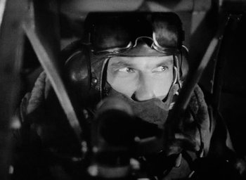 Movie still from “One of Our Aircraft Is Missing” (1942), directed by Emeric Pressburger – A black and white photo of a man wearing a helmet and goggles; Close Up shot, Low angle