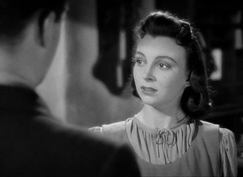 Movie still from “One of Our Aircraft Is Missing” (1942), directed by Emeric Pressburger – An old black and white photo of a woman looking at a man; Close Up shot, Over the shoulder angle