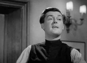 Movie still from “One of Our Aircraft Is Missing” (1942), directed by Emeric Pressburger – A black and white photo of a man looking up at the ceiling; Close Up shot, Low angle