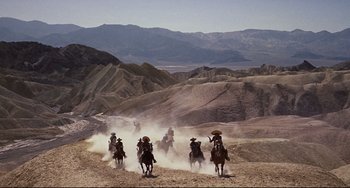 Movie still from “One-Eyed Jacks” (1961), directed by Marlon Brando – A group of people riding horses through the desert; Extreme Wide shot, High angle