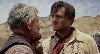 Movie still from “One-Eyed Jacks” (1961), directed by Marlon Brando – Two men are talking to each other in a field; Close Up shot, Over the shoulder angle