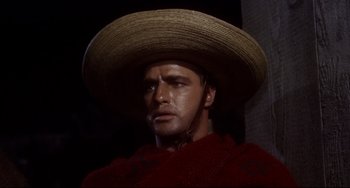 Movie still from “One-Eyed Jacks” (1961), directed by Marlon Brando – A man wearing a sombrero and a red shawl; Close Up shot, Low angle