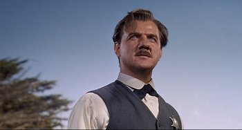 Movie still from “One-Eyed Jacks” (1961), directed by Marlon Brando – A man with a mustache wearing a vest; Close Up shot, Low angle