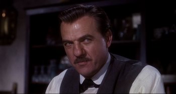 Movie still from “One-Eyed Jacks” (1961), directed by Marlon Brando – A person wearing a suit and tie; Close Up shot, Low angle