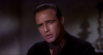 Movie still from “One-Eyed Jacks” (1961), directed by Marlon Brando – A person wearing a suit and tie; Close Up shot, Low angle
