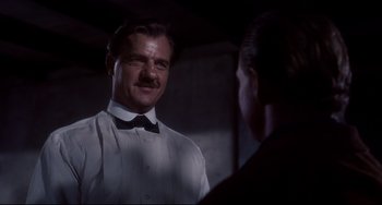 Movie still from “One-Eyed Jacks” (1961), directed by Marlon Brando – A man wearing a bow tie talking to another man; Close Up shot, Low angle