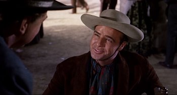 Movie still from “One-Eyed Jacks” (1961), directed by Marlon Brando – A man with a hat and a jacket on; Close Up shot, Over the shoulder angle