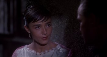 Movie still from “One-Eyed Jacks” (1961), directed by Marlon Brando – A young woman in a white dress looking at the camera; Close Up shot, Over the shoulder angle