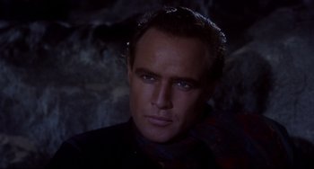 Movie still from “One-Eyed Jacks” (1961), directed by Marlon Brando – A person wearing a suit and tie; Close Up shot, Over the shoulder angle