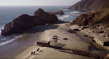 Movie still from “One-Eyed Jacks” (1961), directed by Marlon Brando – A group of people riding horses on a beach; Extreme Wide shot, High angle