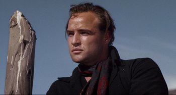 Movie still from “One-Eyed Jacks” (1961), directed by Marlon Brando – A person wearing a jacket and a scarf; Close Up shot, Low angle