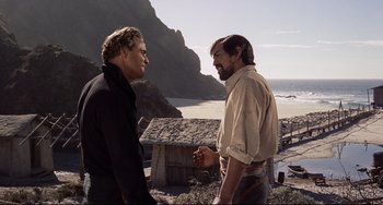 Movie still from “One-Eyed Jacks” (1961), directed by Marlon Brando – Two men are standing on the beach and talking to each other; Medium shot, Over the shoulder angle