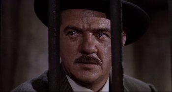 Movie still from “One-Eyed Jacks” (1961), directed by Marlon Brando – A person behind a fence; Close Up shot, Low angle