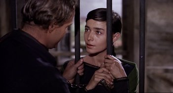 Movie still from “One-Eyed Jacks” (1961), directed by Marlon Brando – A man and a woman holding hands in a room; Close Up shot, Over the shoulder angle