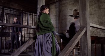Movie still from “One-Eyed Jacks” (1961), directed by Marlon Brando – A woman in a green dress and a man in a cowboy hat; Medium shot, Low angle