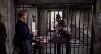 Movie still from “One-Eyed Jacks” (1961), directed by Marlon Brando – Two men are in a jail cell with cell phones in their hands; Medium shot, Low angle