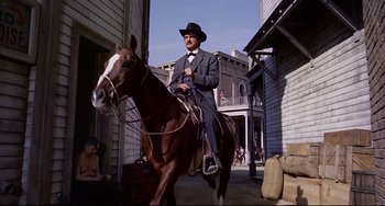 Movie still from “One-Eyed Jacks” (1961), directed by Marlon Brando – A man in a suit and hat riding a horse; Wide shot, Low angle