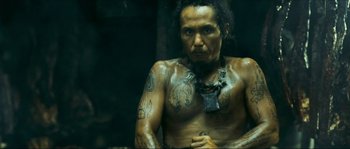 Movie still from “Ong Bak 2” (2008), directed by Tony Jaa – A man with tattoos on his arms and chest; Medium shot, Low angle