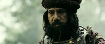 Movie still from “Ong Bak 2” (2008), directed by Tony Jaa – A person with a beard; Close Up shot, Low angle