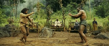 Movie still from “Ong Bak 2” (2008), directed by Tony Jaa – A group of people sitting on chairs in the grass; Wide shot, High angle