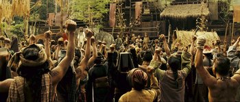 Movie still from “Ong Bak 2” (2008), directed by Tony Jaa – A group of people standing in front of a building; Wide shot, High angle
