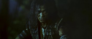 Movie still from “Ong Bak 2” (2008), directed by Tony Jaa – A person with long black hair; Close Up shot, Low angle