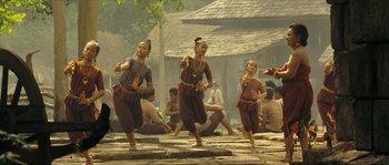Movie still from “Ong Bak 2” (2008), directed by Tony Jaa – A group of young people are dancing in the street; Wide shot, Low angle