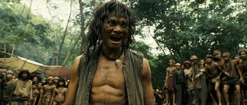 Movie still from “Ong Bak 2” (2008), directed by Tony Jaa – A man with long hair and a bare tortoiseshell face; Medium shot, Low angle