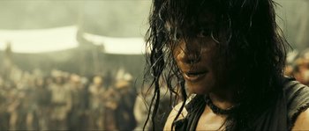 Movie still from “Ong Bak 2” (2008), directed by Tony Jaa – A woman's face with long black hair; Close Up shot, Over the shoulder angle
