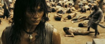 Movie still from “Ong Bak 2” (2008), directed by Tony Jaa – A woman standing in the middle of a field; Close Up shot, High angle