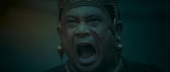Movie still from “Ong Bak 2” (2008), directed by Tony Jaa – A man with a gold crown is screaming; Close Up shot, Low angle