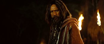 Movie still from “Ong Bak 2” (2008), directed by Tony Jaa – A man with long hair and a long beard; Close Up shot, Low angle
